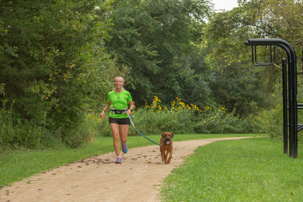 Woman running with her dog on the Galena River Trail