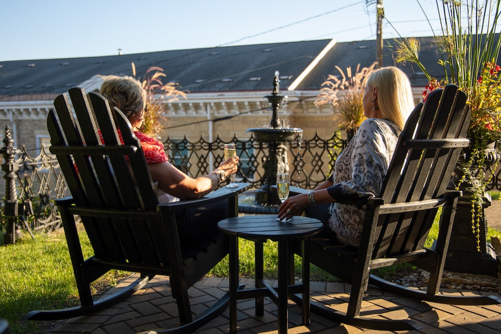 Two women relaxing and enjoy the patio at our Galena Bed and Breakfast, another great place to unwind after a walk on the Galena River Trail