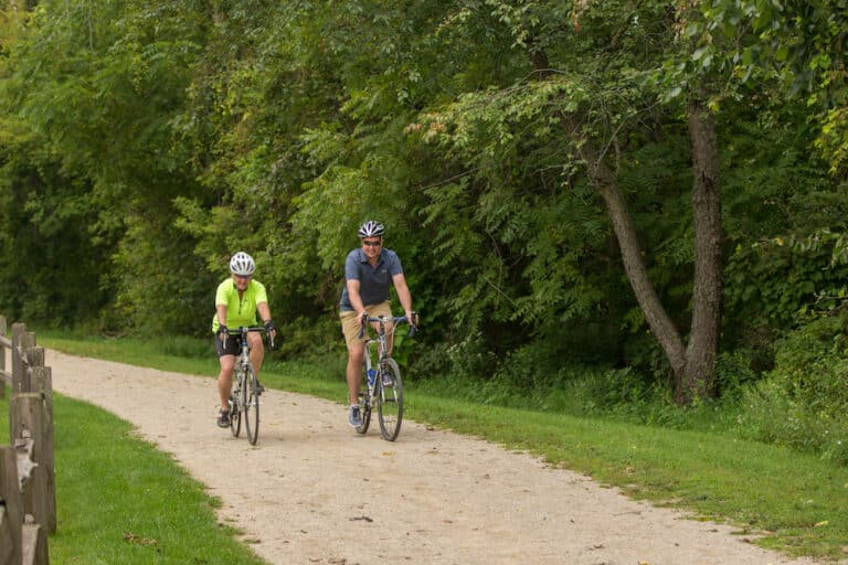 Two people biking on the Galena River Trail