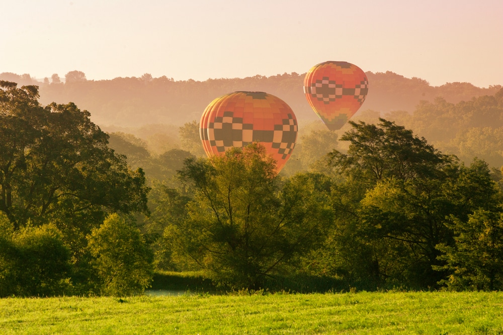 Two hot air balloons taking off for gorgeous views like those you'd see on a Galena hot air balloon ride