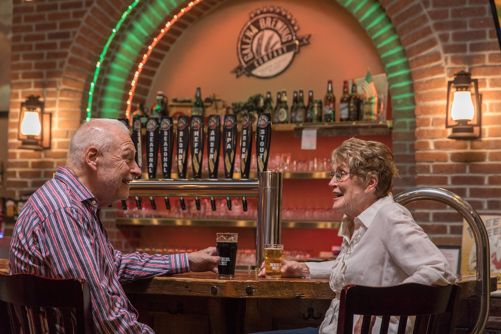 A senior couple enjoy beers at the Galena Brewing Company near our galena Bed and Breakfast