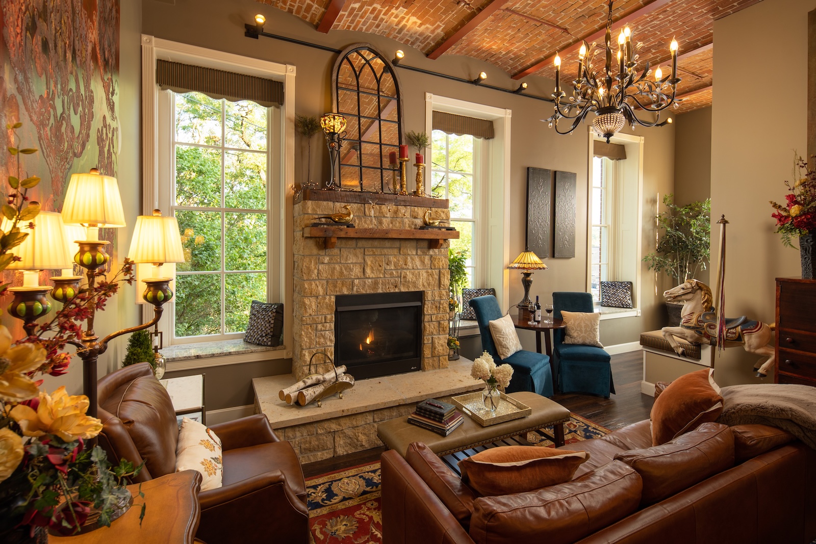 Galena in the Fall: A Complete Guide to Your Getaway 3 A large sitting room with a stone fireplace, couch, and lamps at a cozy bed and breakfast Galena IL.