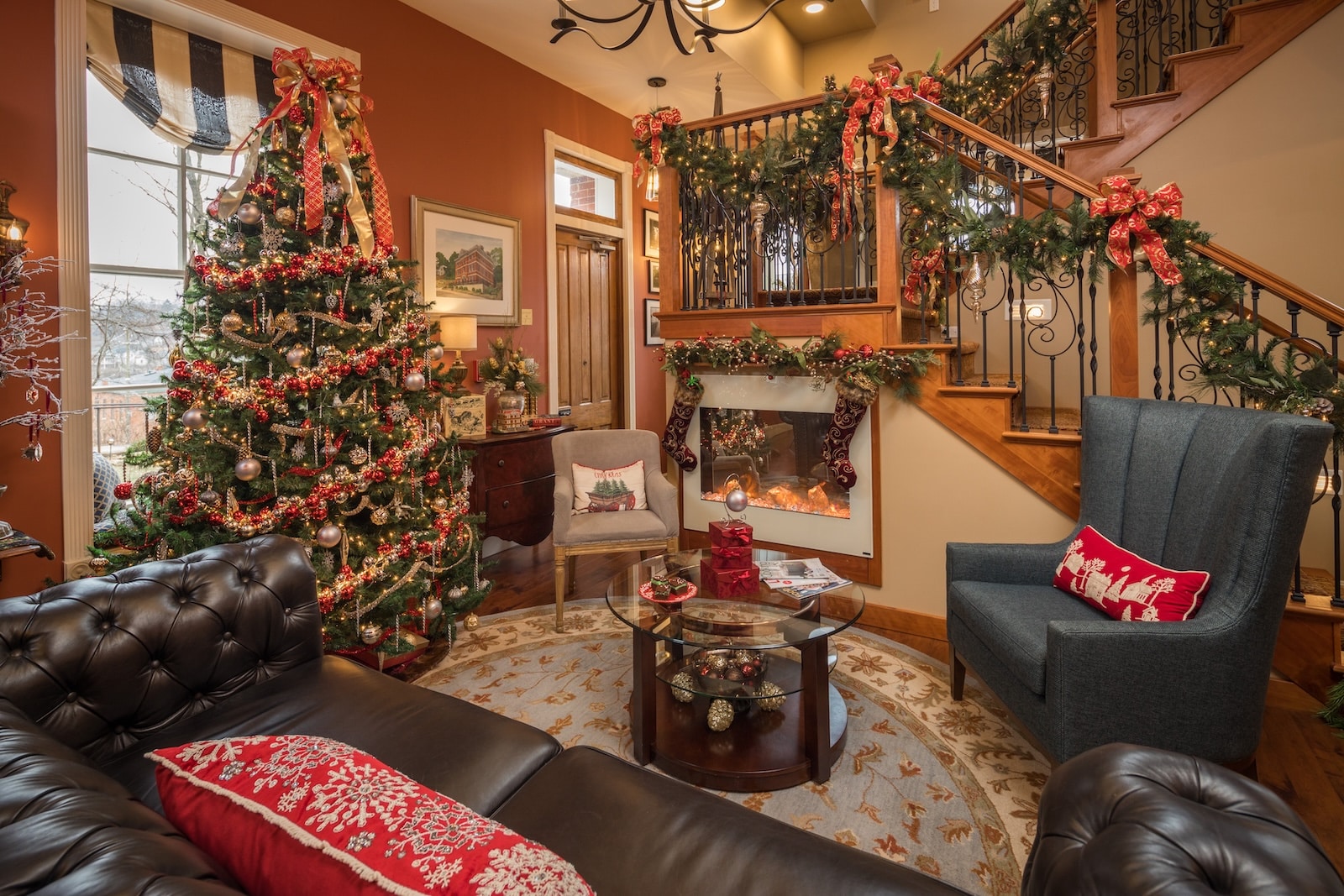 Christmas in Galena, IL: A Complete Guide to the Holiday Season 2 A Christmas tree by a fireplace and staircase in a common seating area of a Galena Bed and Breakfast.