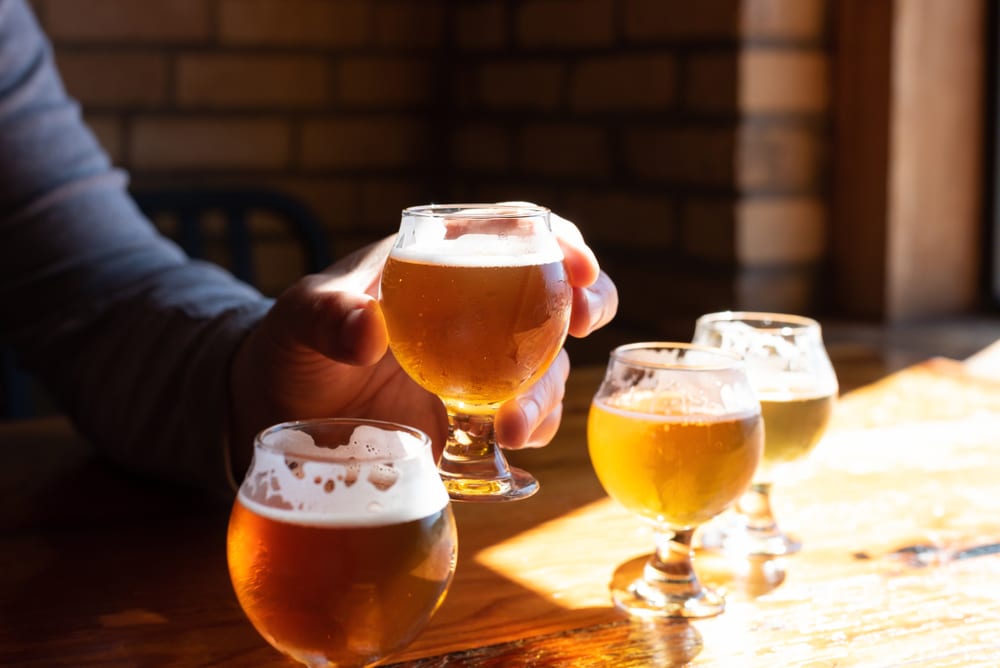 Man holding a craft beer at one of the best Galena breweries in Illinois