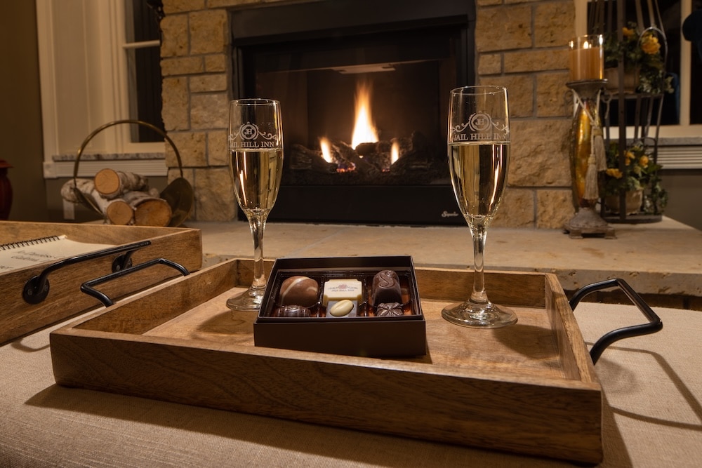 romantic champagne glasses by the fire during Galena romantic getaways at Jail Hill Inn