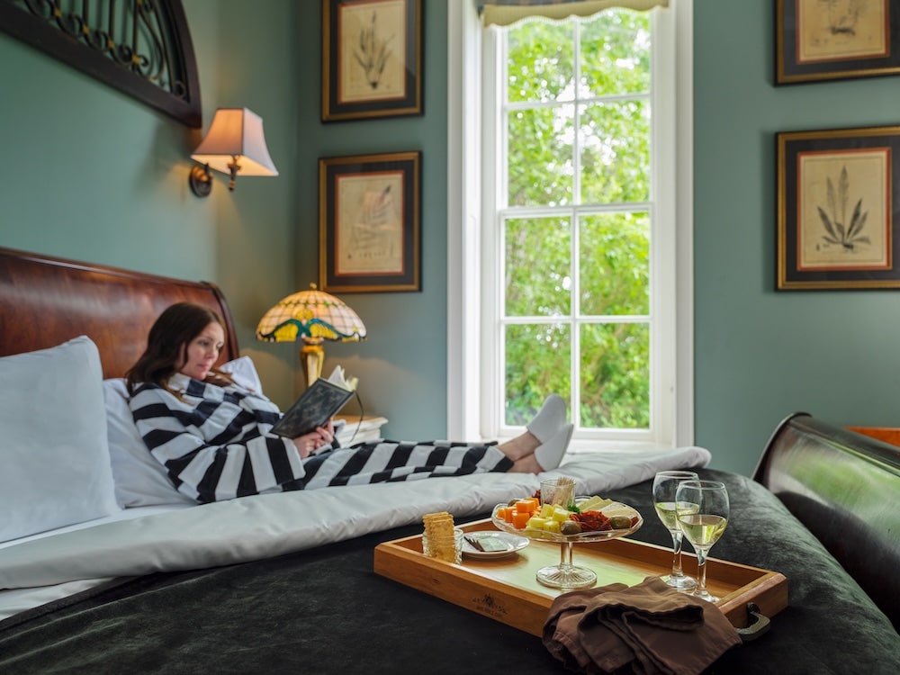 Woman lounging and enjoying our daily wine and appetizers - one of the many reasons we're the best couples getaway in Illinois
