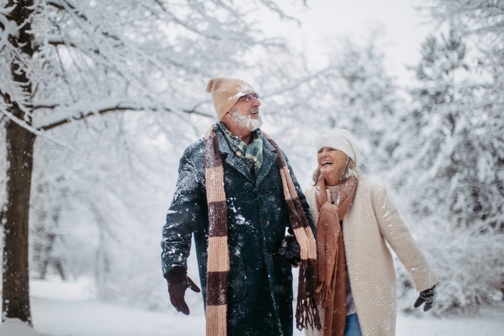 Romantic couple walking in the snow, and enjoying the best things to do in Galena, IL in winter