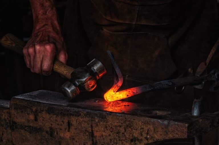 Welcome 6 A blacksmith manually forging the molten metal on the anvil at the Old Blacksmith Shop in Galena, IL.